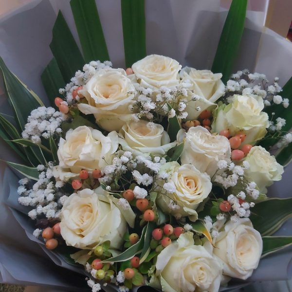 12 PCS OF WHITE ROSES IN GREY WRAPPER