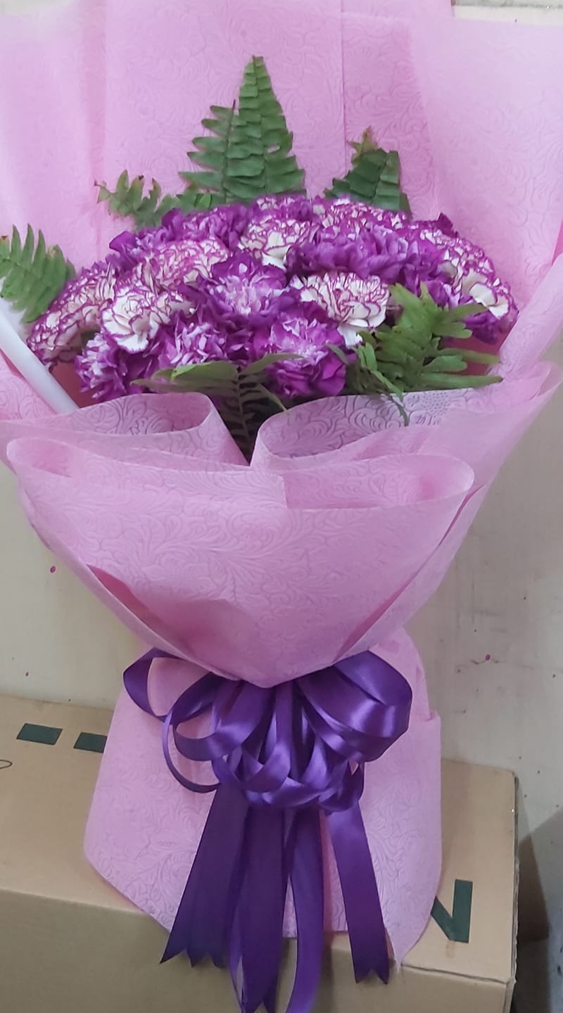 violet carnation in a bouquet in a purple wrapper